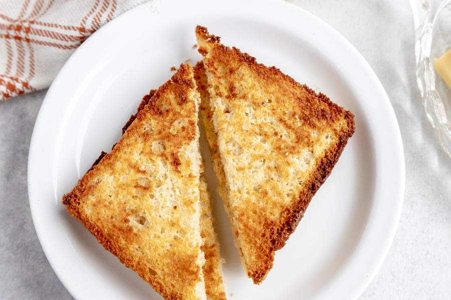 toast cut diagonally on a white plate