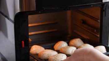 sliding an air fryer tray into the oven