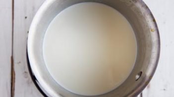 a sauce pan with lemon cream sauce in it