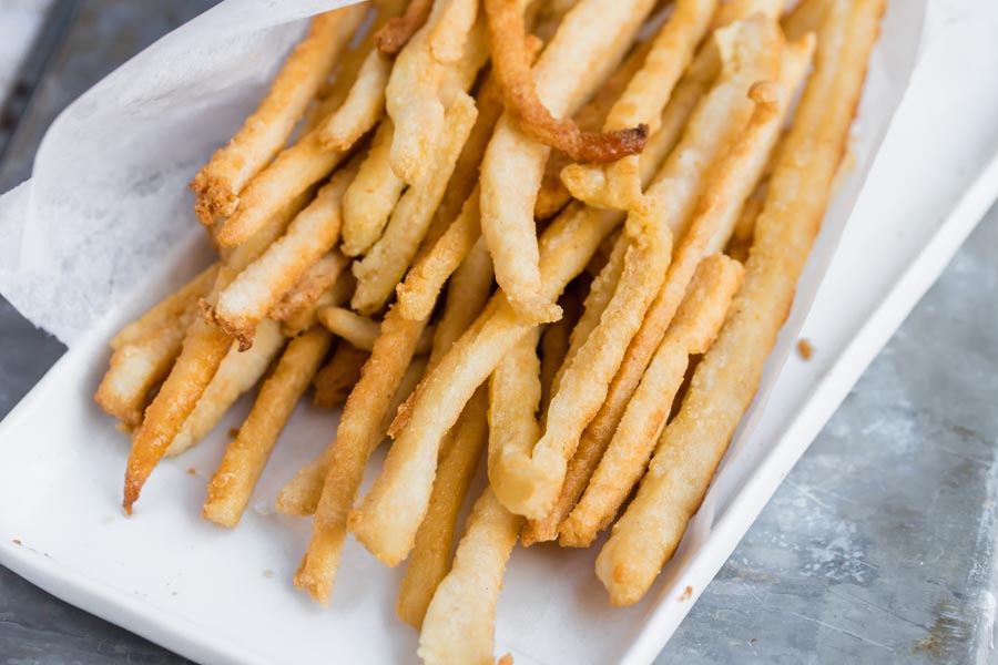 a bundle of crispy fries wrapped in paper