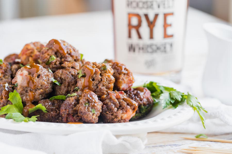 plate of low carb meatbals with bbq sauce drizzled on top