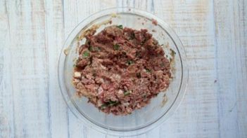 glass bowl with mixed meatball mixture in it