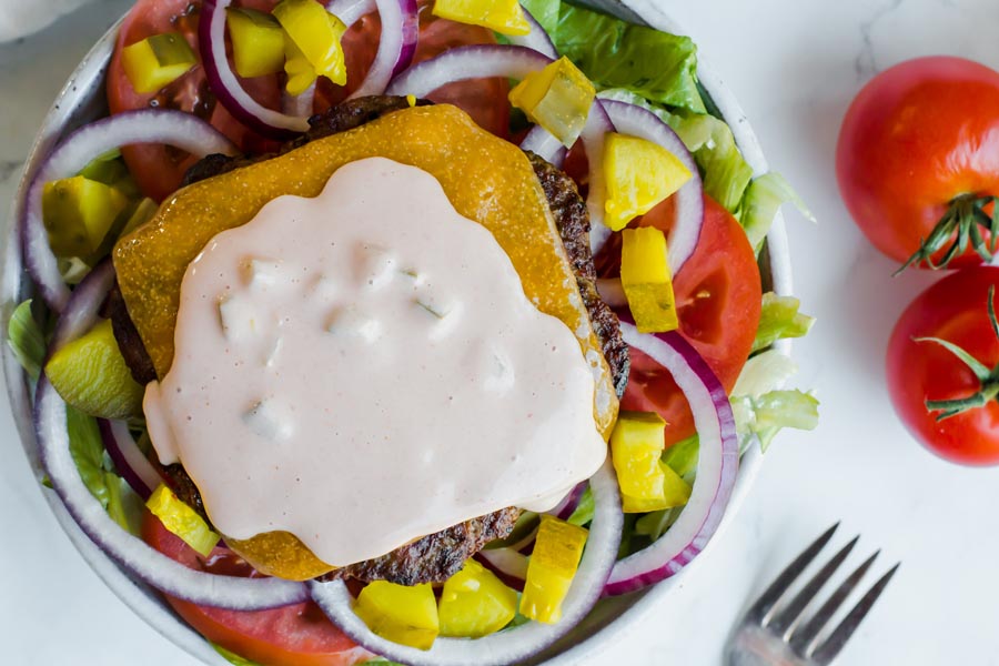 overhead of keto big mac salad with creamy dressing