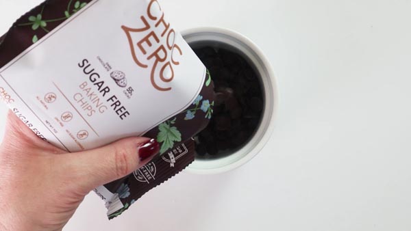 pouring choczero chocolate chips in a small bowl