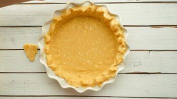 unbaked pie crust in a pan with fluted edges