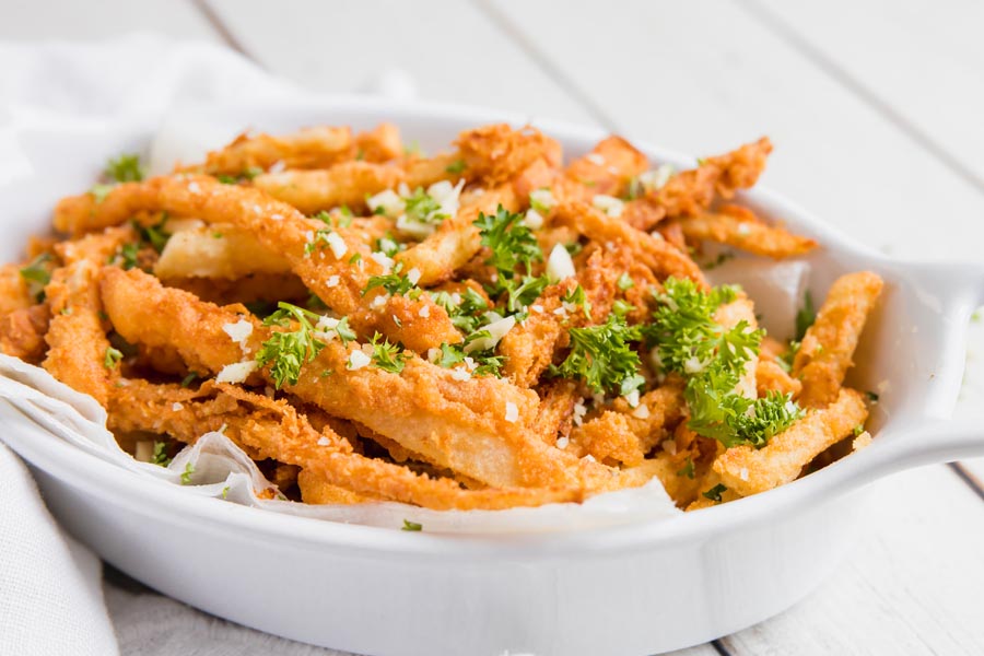 a bunch of garlic parmesan fried jicama on a plate