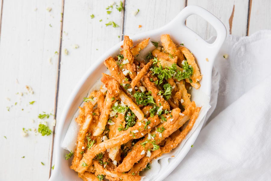 overhead view of a basket of garlic parm jicama fries