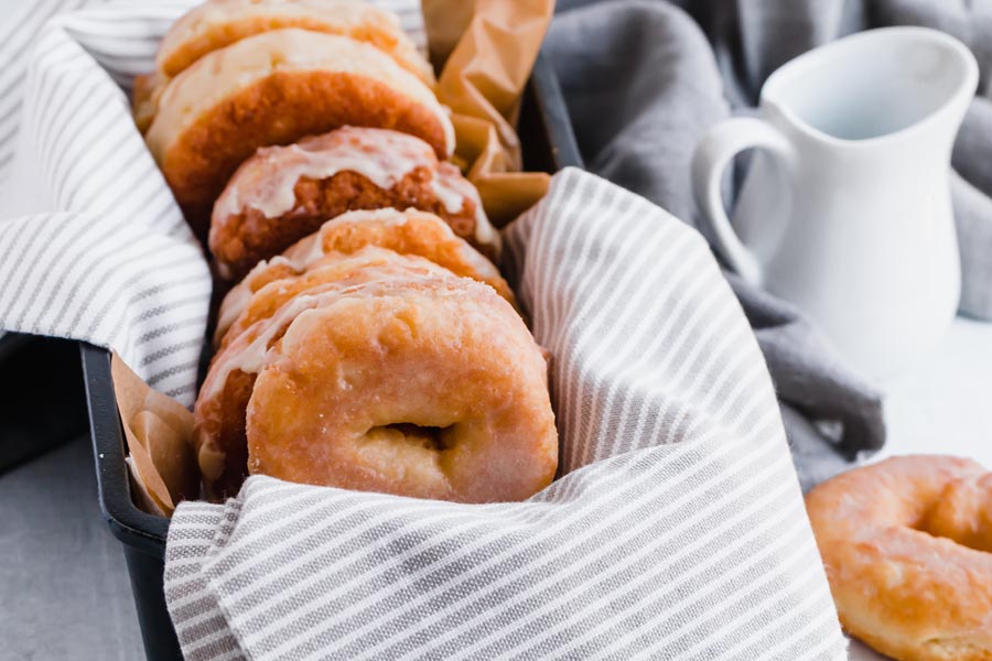 krispy kreme donuts in a loaf pan with a linen towel