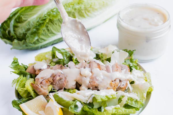 caesar dressing next to chicken salad