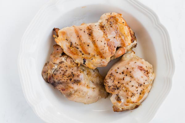 Cooked chicken in white bowl