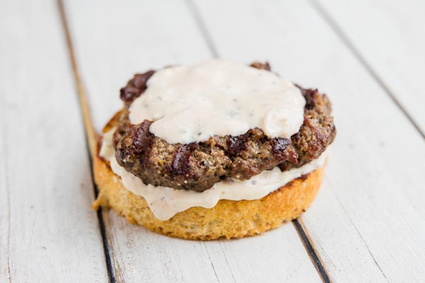 horseradish sauce on a burger with lettuce and tomato