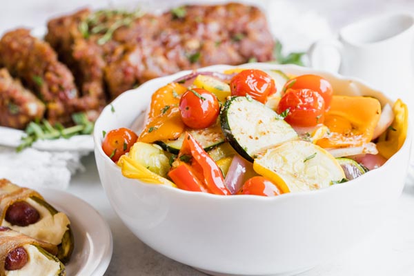 cooked veggies in a white bowl on the dinner table