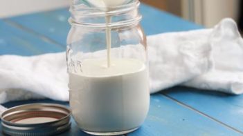 pouring heavy cream into a mason jar