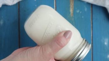 shaking a mason jar with cream