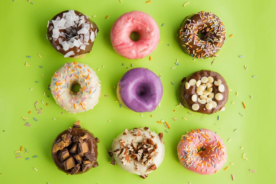 nine donuts with different frostings and toppings