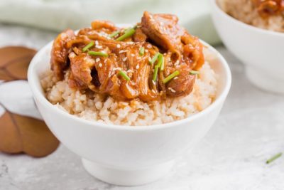 big bowl of keto sesame maple chicken over cauliflower rice