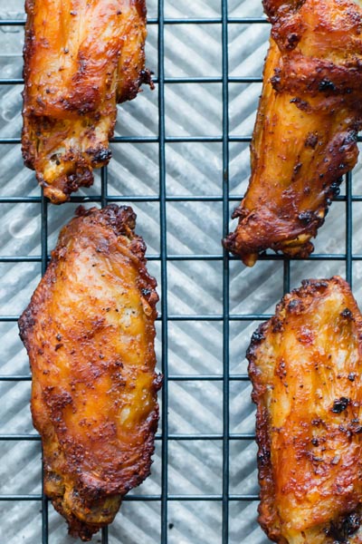 Close up photo showing air fried crispy chicken wings on a tray.