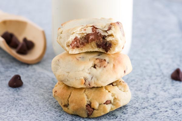 gooey center of a chocolate chip cookie stacked on top and half bitten