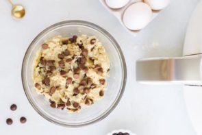 chocolate chip cookie dough in a bowl next to an air fryer