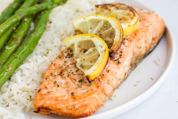 air fryer salmon on a plate with cauliflower rice and asparagus