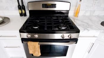 A stovetop oven in a white kitchen.