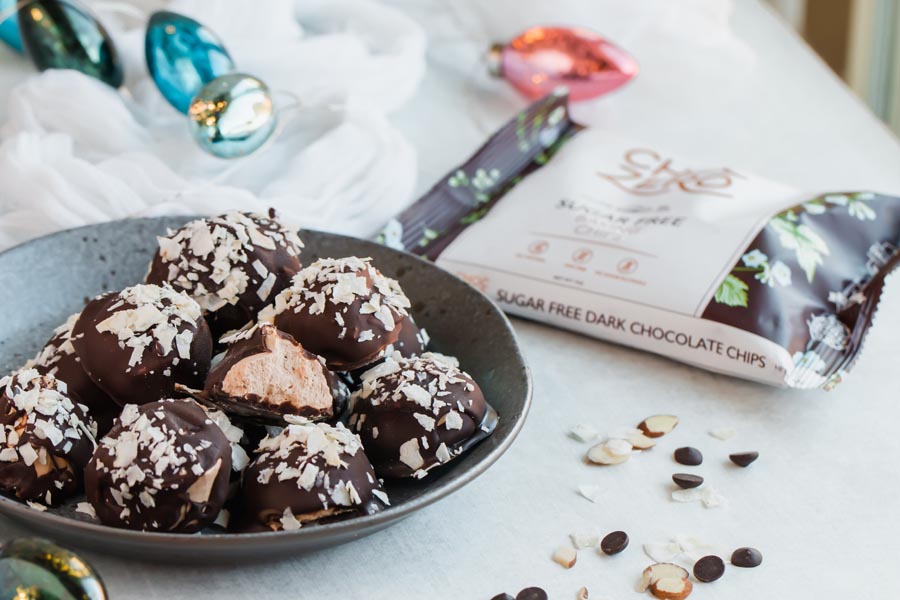 keto cream truffles on a plate with chocolate chips for the holidays