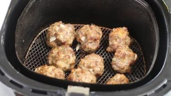 asian meatballs in an air fryer basket