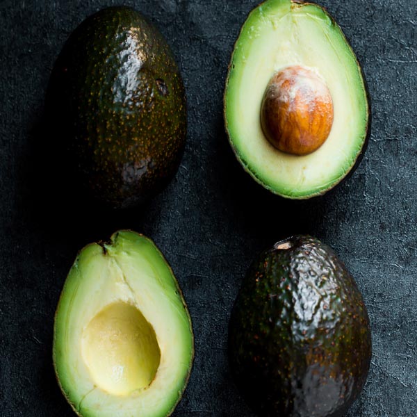 four halves of green avocados