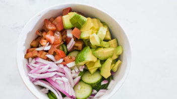 Keto avocado cucumber salad ingredients sitting unmixed in a bowl