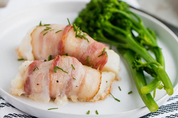 chives sprinkled on top of baked fish with a side of broccoli