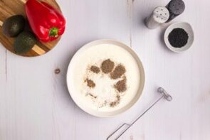 A shallow bowl with cream and seasoning in it.