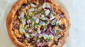 Steaming hot keto BBQ pulled pork pizza sitting on a table