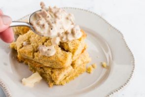 a spoon holding a bite of keto biscuits and gravy