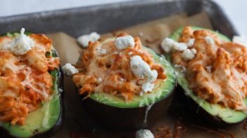 buffalo chicken mixture inside an avocado