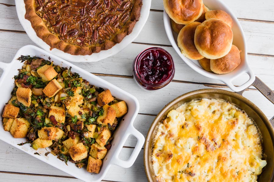 holiday side dishes on a white wooden table