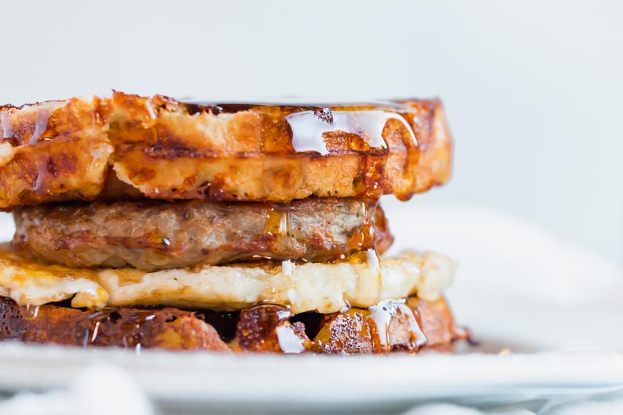 maple syrup dripping from a keto breakfast sandwich