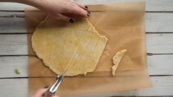 slicing egg noodles with a pizza cutter