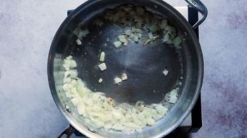 butter and onion sautéing in a skillet