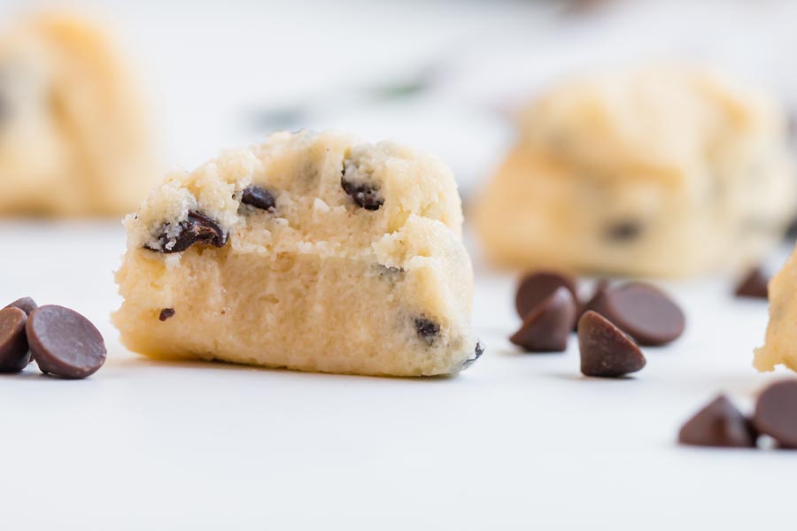 teeth marks in a ball of cookie dough and chocolate chips scattered around