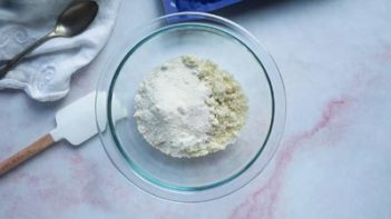 dry ingredients in a glass bowl with a spatula