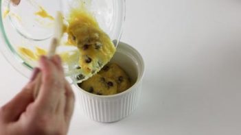 pouring keto cake batter into a small ramekin