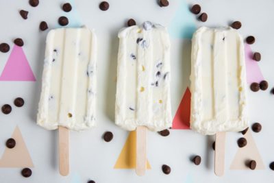 three creamy white yogurt bars in a row with chocolate chips around