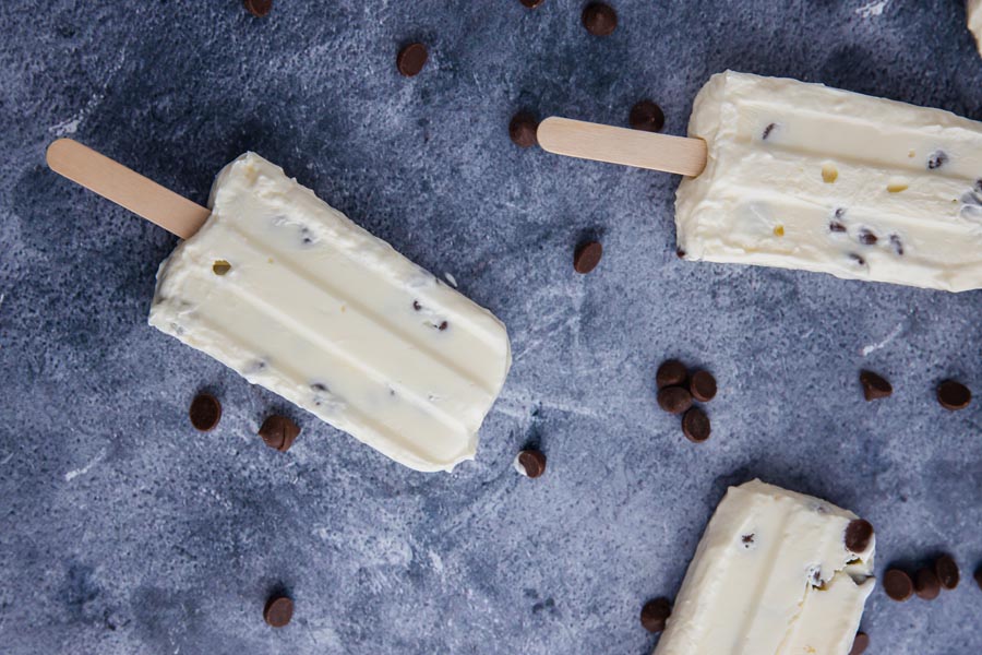 three yogurt popsicles with chocolate chips around