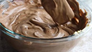 folding a creamy chocolate filling in a bowl