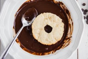 donut dipped into melted chocolate