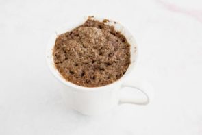 small baked chocolate cake in a white mug