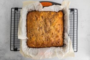 A baked cake in a square baking dish.