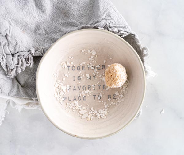 a single coconut covered ball in a bowl that says together is my favorite place