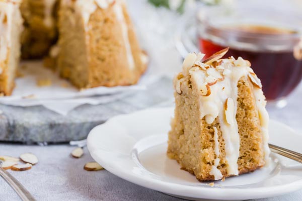 a slice of coffee cake in front of a cup of coffee