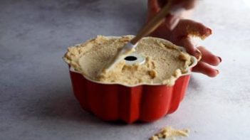 spreading cake batter into a bundt pan